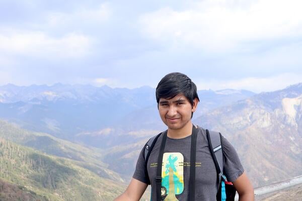 Man standing in front of mountains