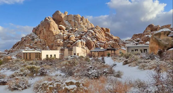 Field station buildings among rocks in snow