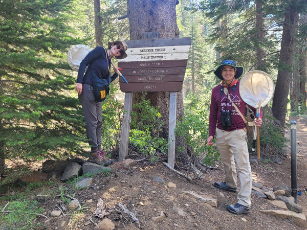 Students in front of forest sign